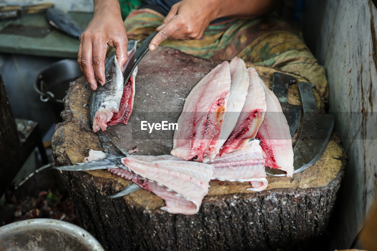 Fresh fish cutting at retail shop for sale at day from different angle