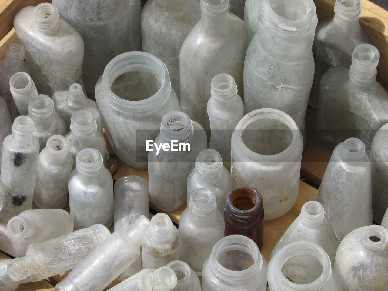 High angle view of empty old bottles in container