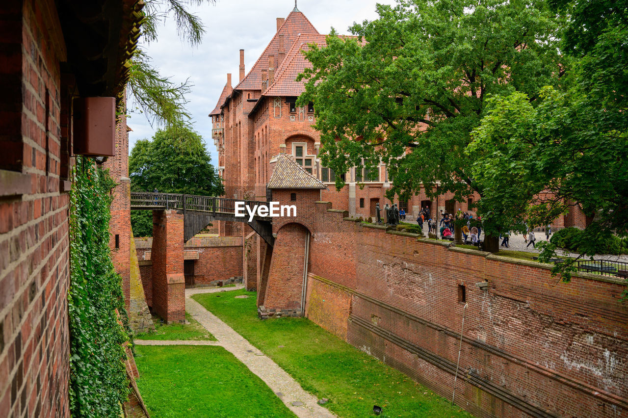 EXTERIOR OF HISTORIC BUILDING AMIDST TREES