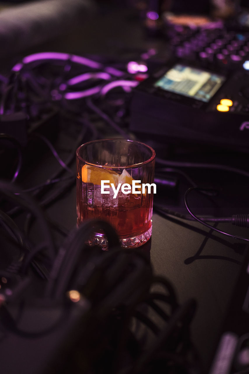 Close-up of drink on dj set