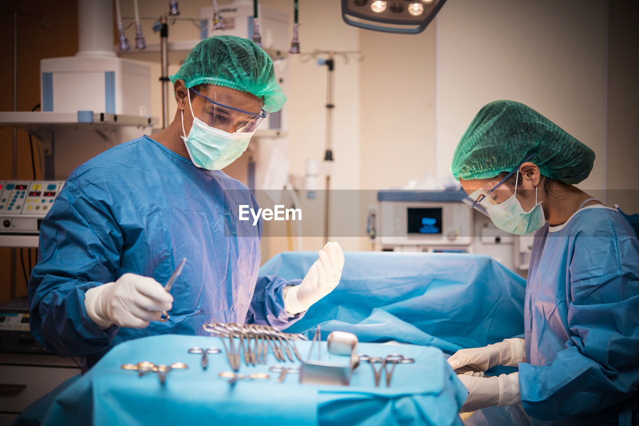 Surgeons performing operation on patient at hospital