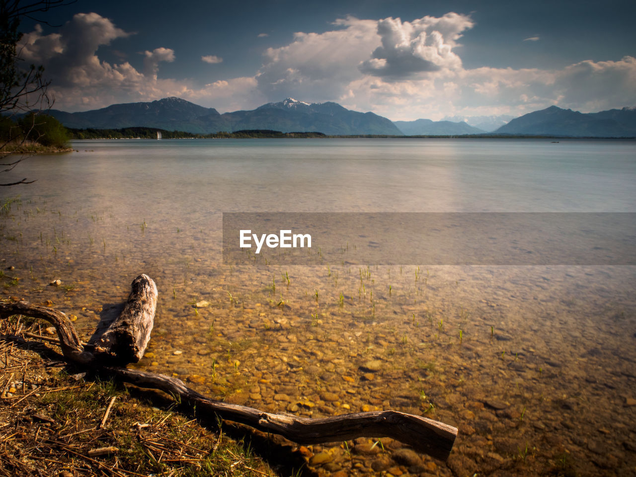 Scenic view of lake against cloudy sky