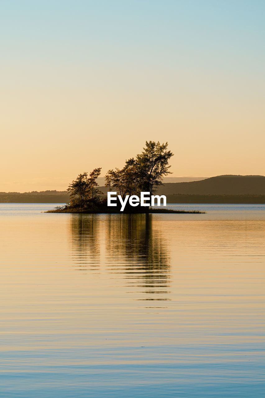 Scenic view of lake against sky during sunset