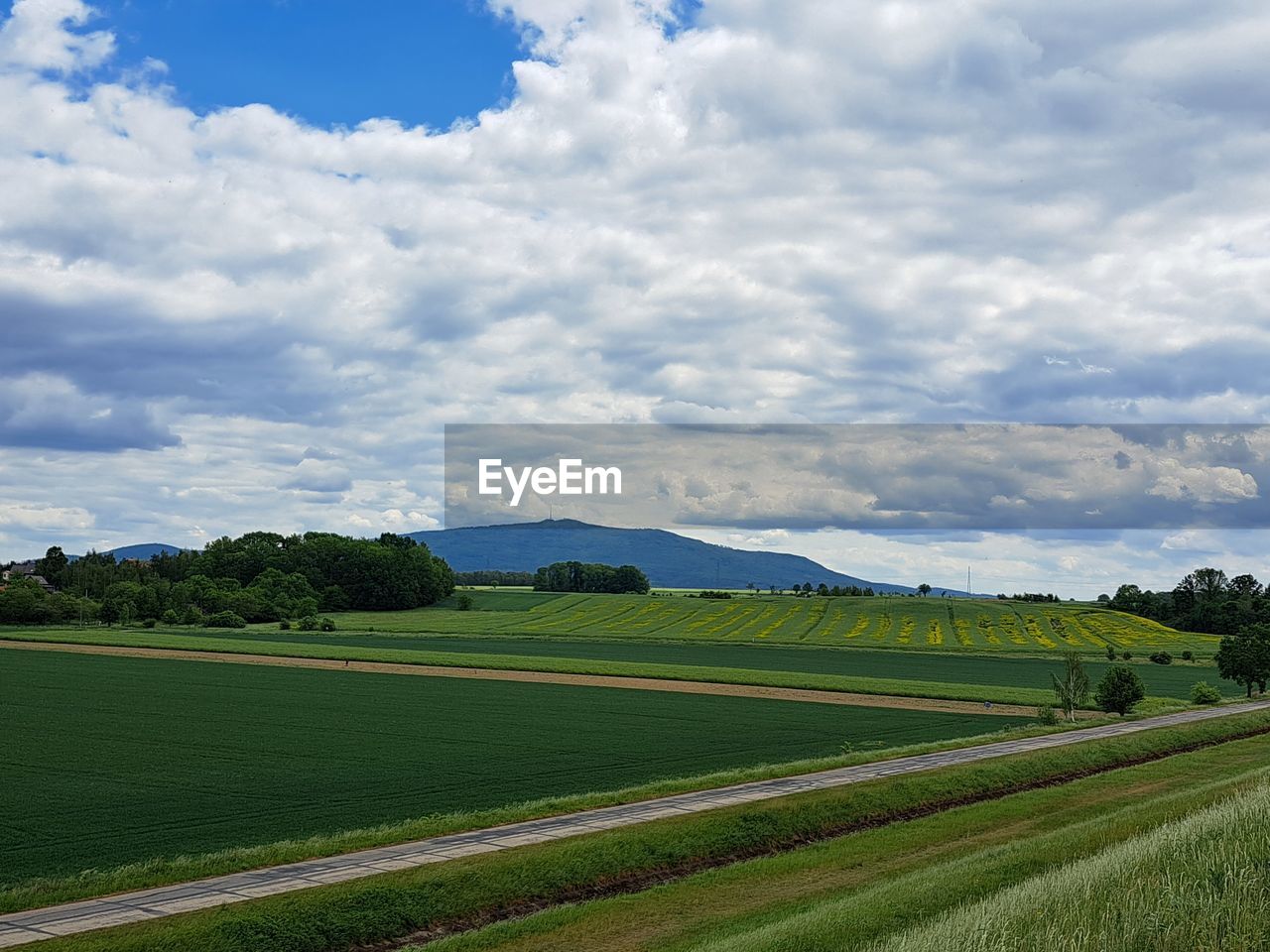 Scenic view of agricultural field and sleza mountain against sky in poland.