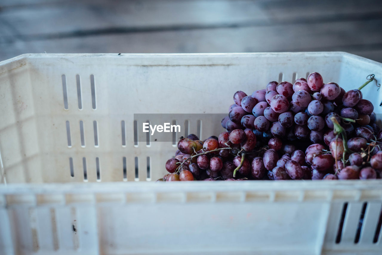 Close-up of red grapes in crate