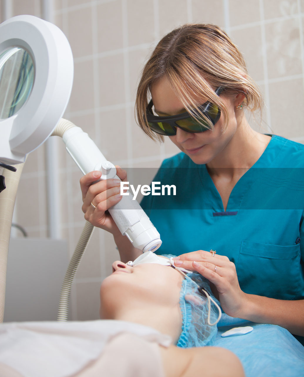 Close-up of woman getting beauty treatment from doctor