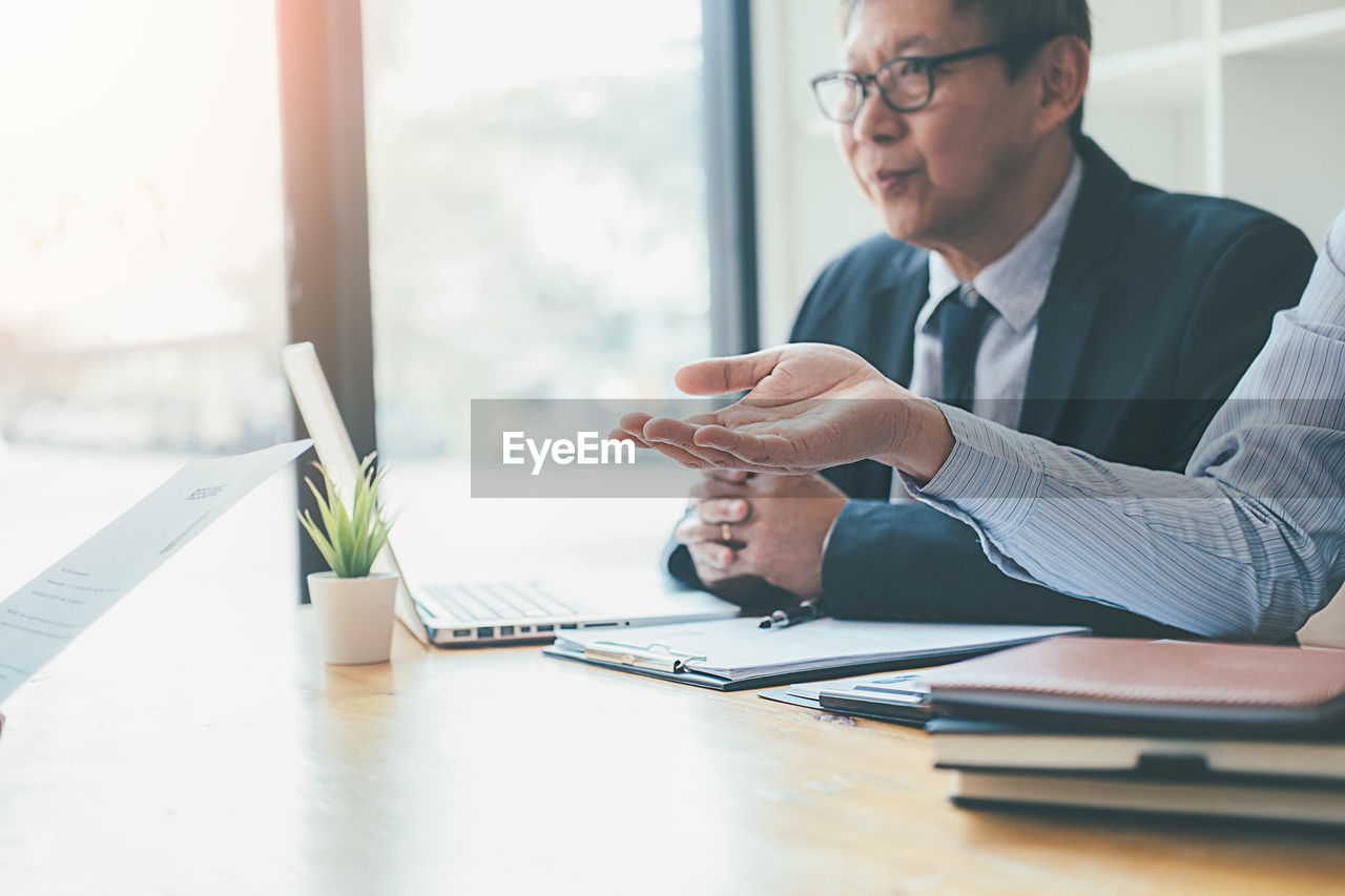 Businessman and colleague working on table