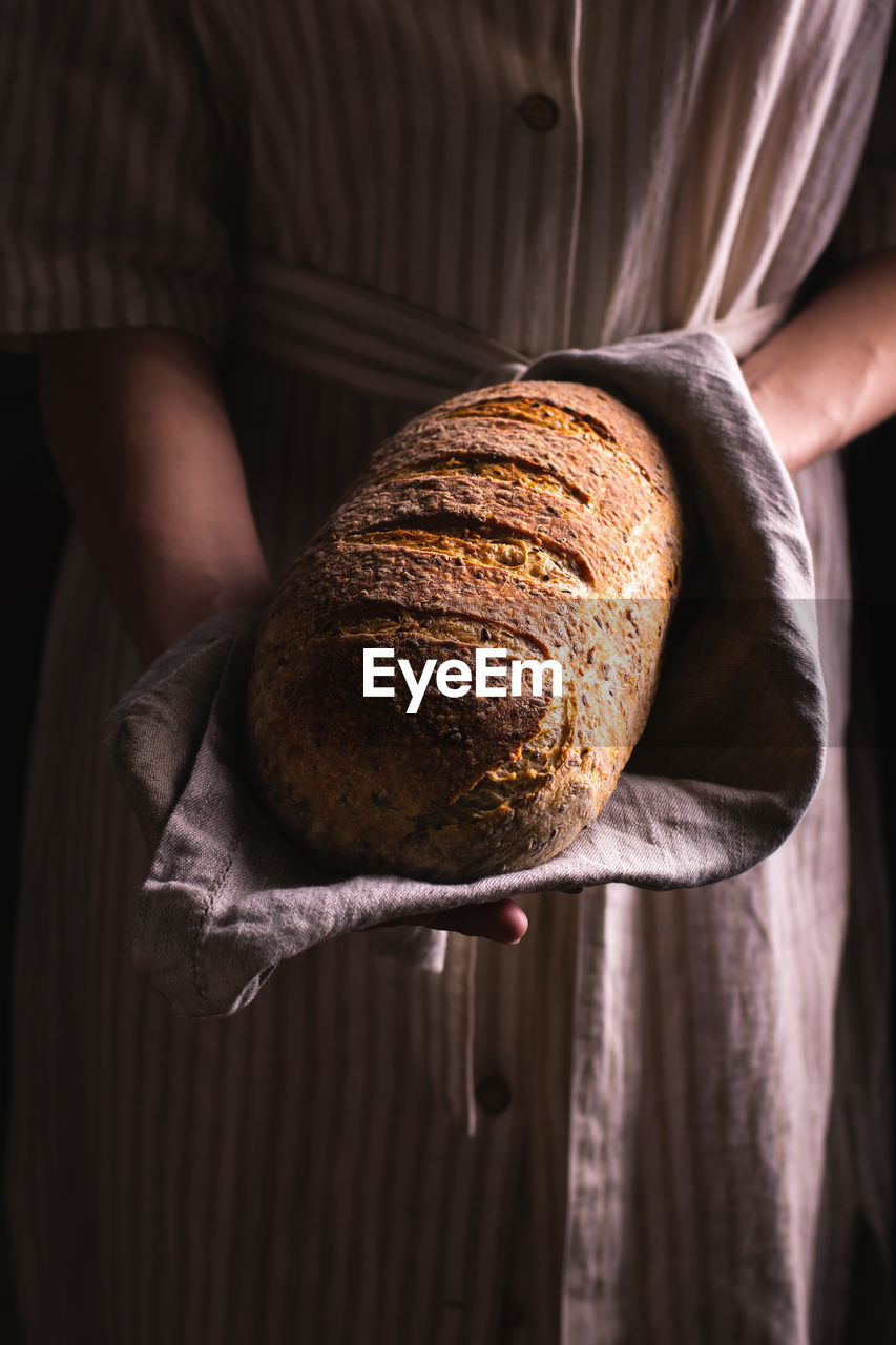 Woman holding a loaf of freshly baked bread