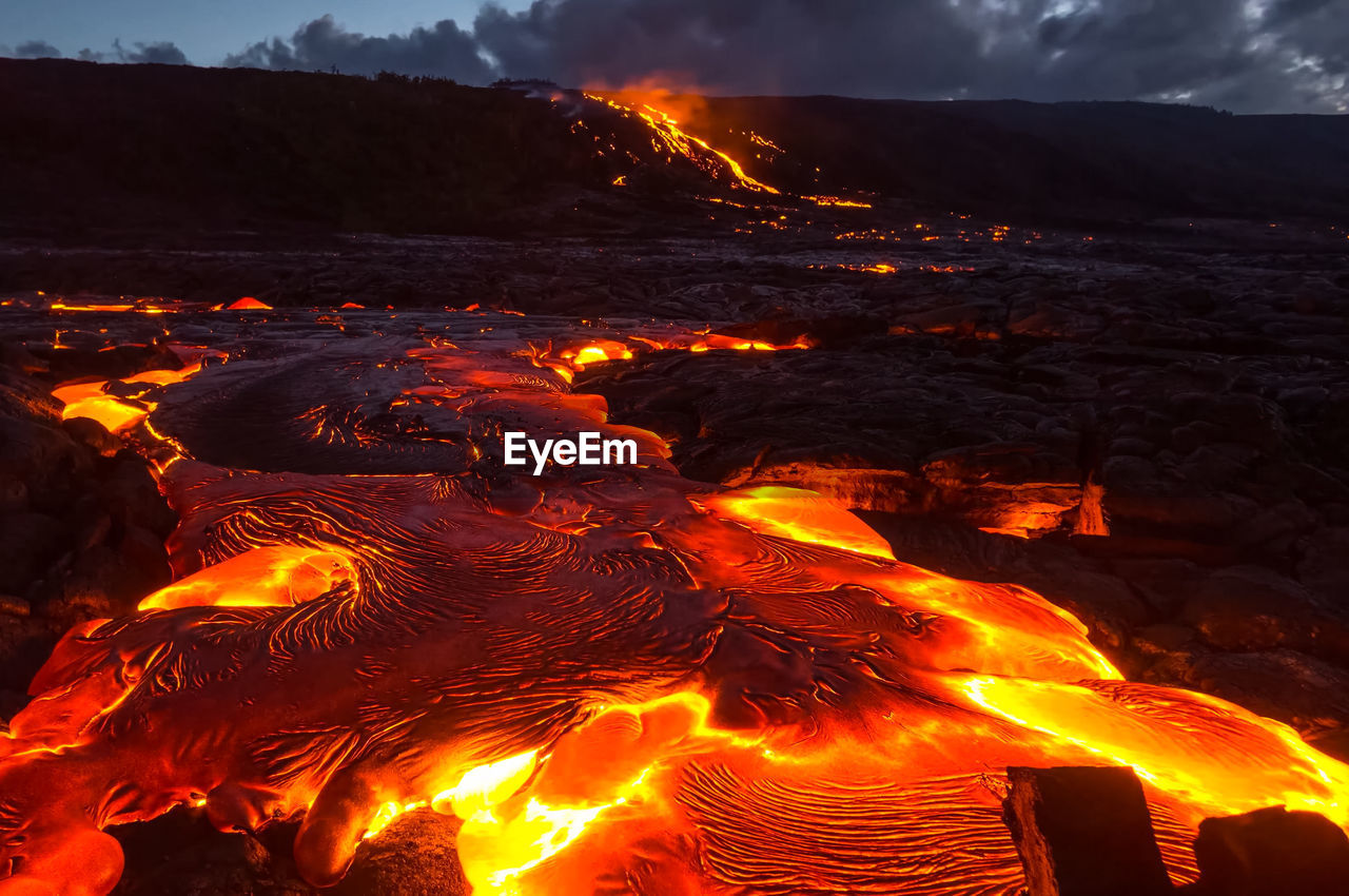 VIEW OF BONFIRE AGAINST MOUNTAIN