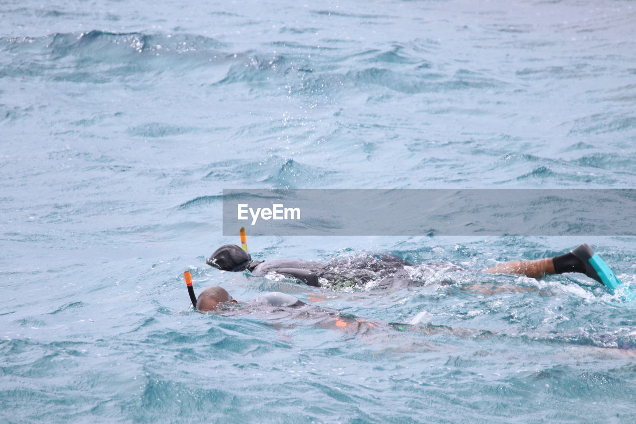 People swimming in sea