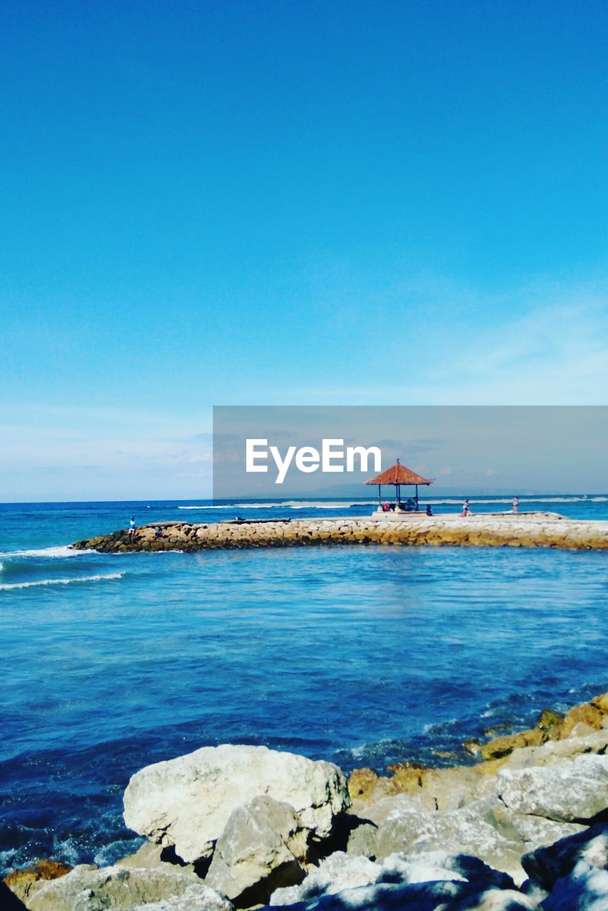 Scenic view of sea against blue sky