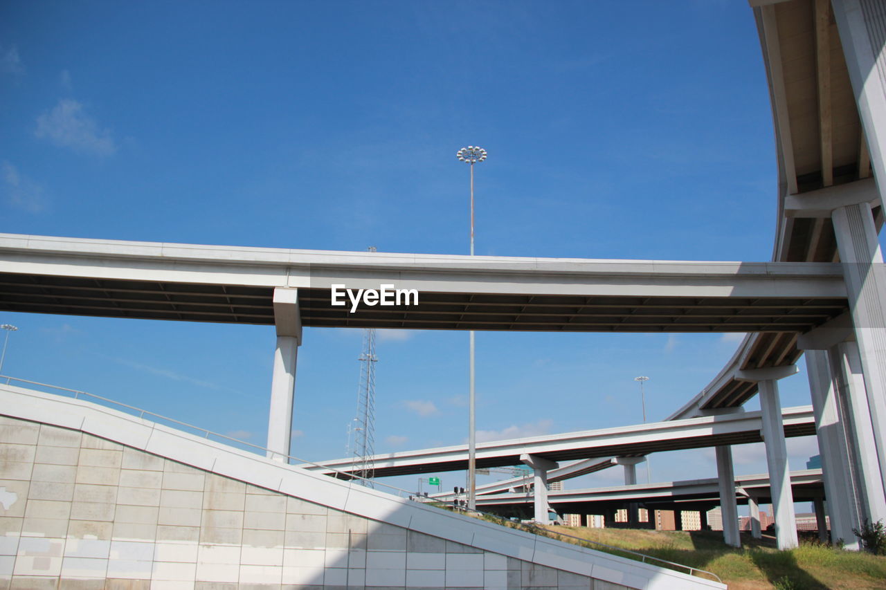 Low angle view of bridges against clear blue sky