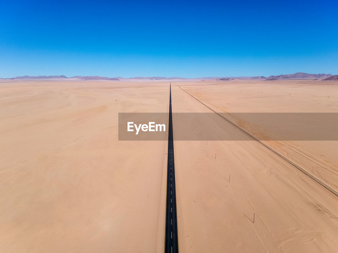 Drone - straight b4 desert road and train line between lüderitz and keetmanshoop in namibia, africa.