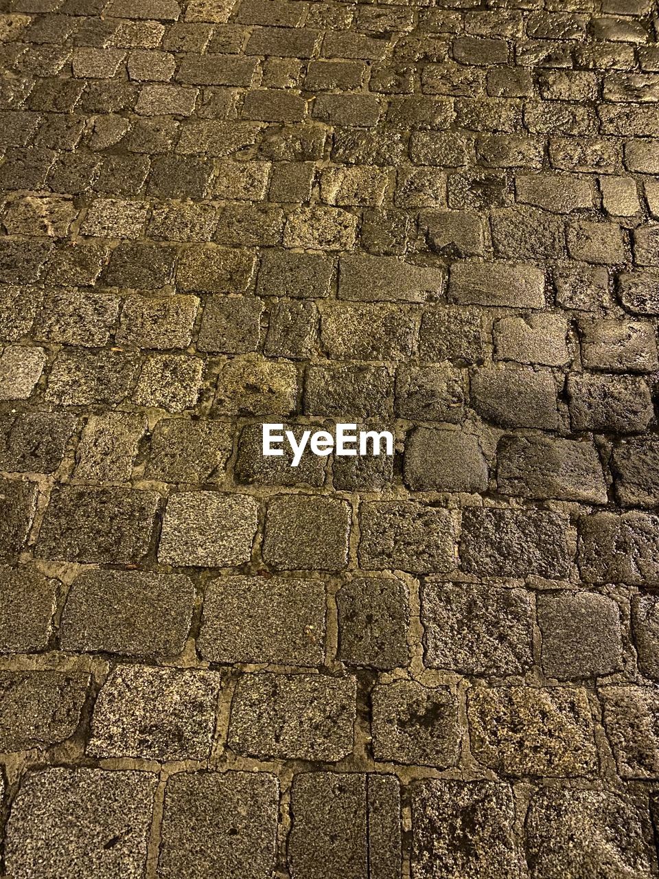 FULL FRAME SHOT OF STONE WALL WITH STREET