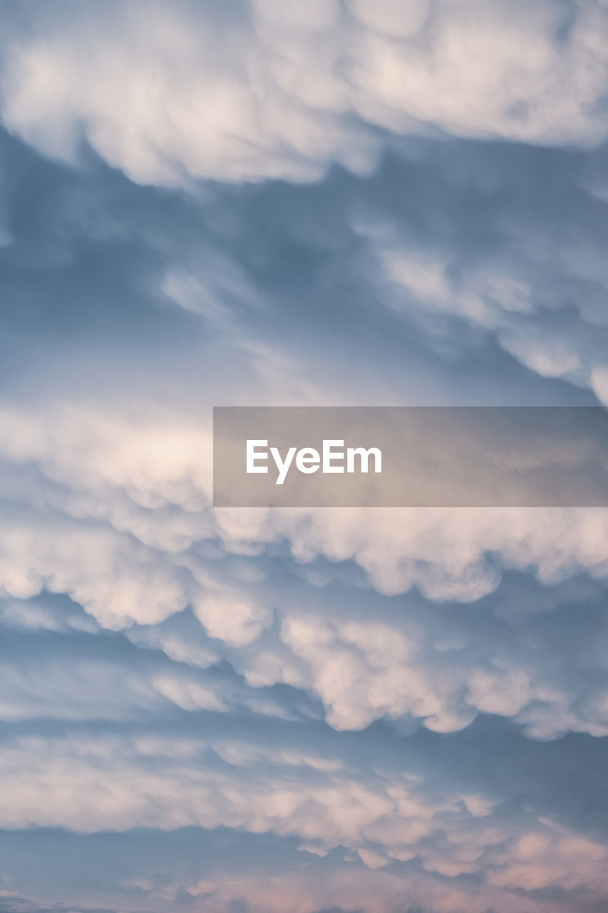 sky, cloud, beauty in nature, cloudscape, scenics - nature, nature, dramatic sky, environment, horizon, no people, tranquility, idyllic, outdoors, tranquil scene, backgrounds, overcast, day, sunlight, atmosphere, blue, landscape, awe, moody sky, mountain, storm cloud