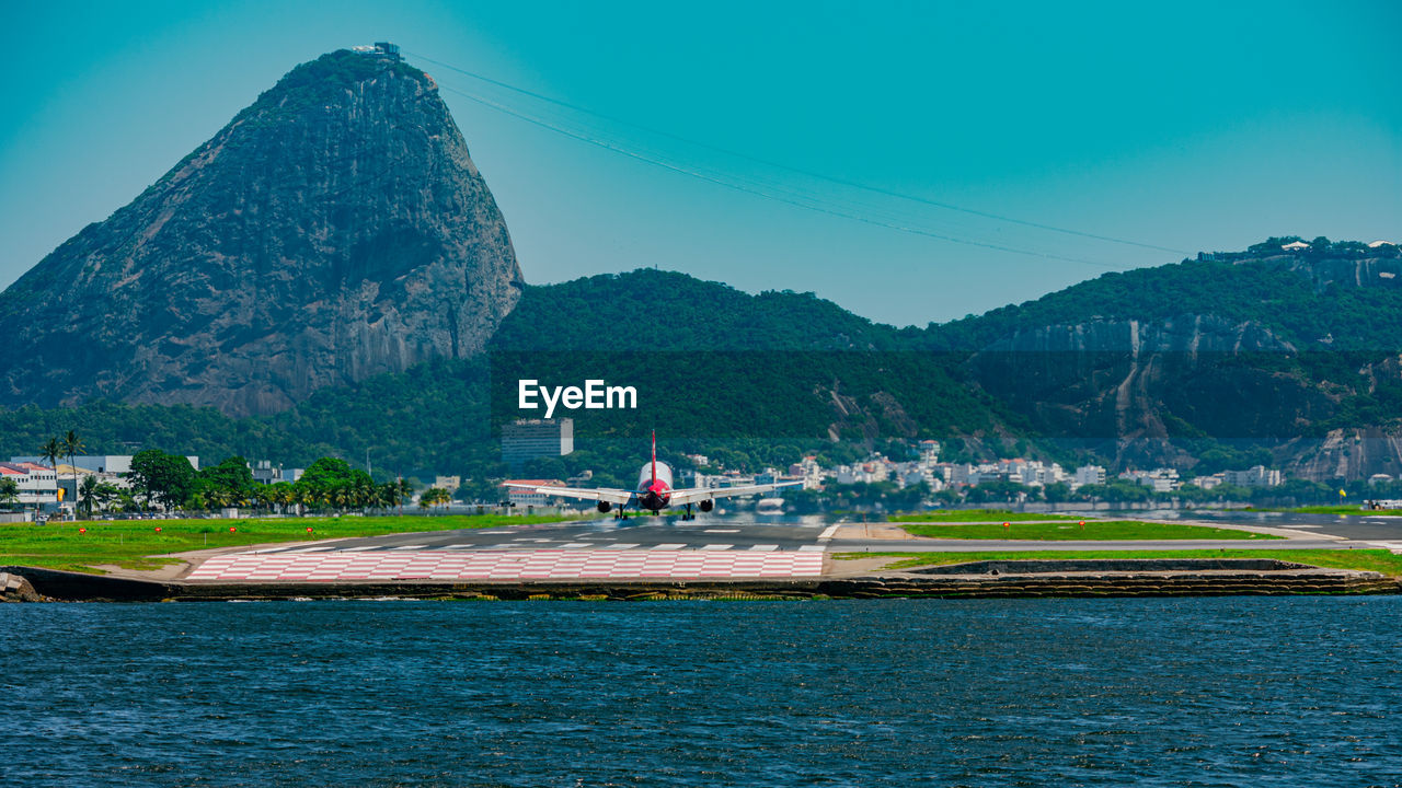 Commercial plane landing on the runway at santos dumont national airport.
