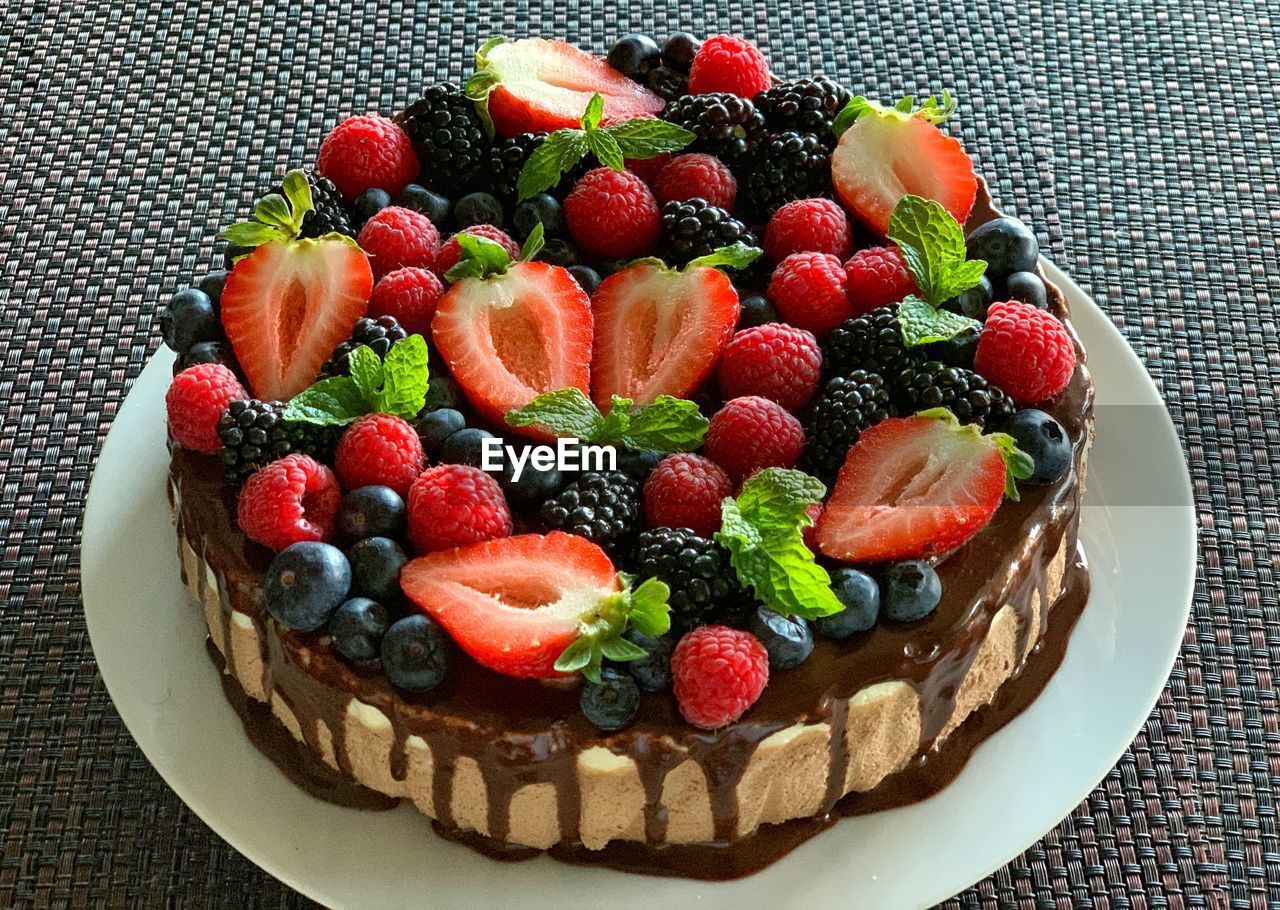  chocolate mousse cake  and fresh mixed berry fruit   on the table