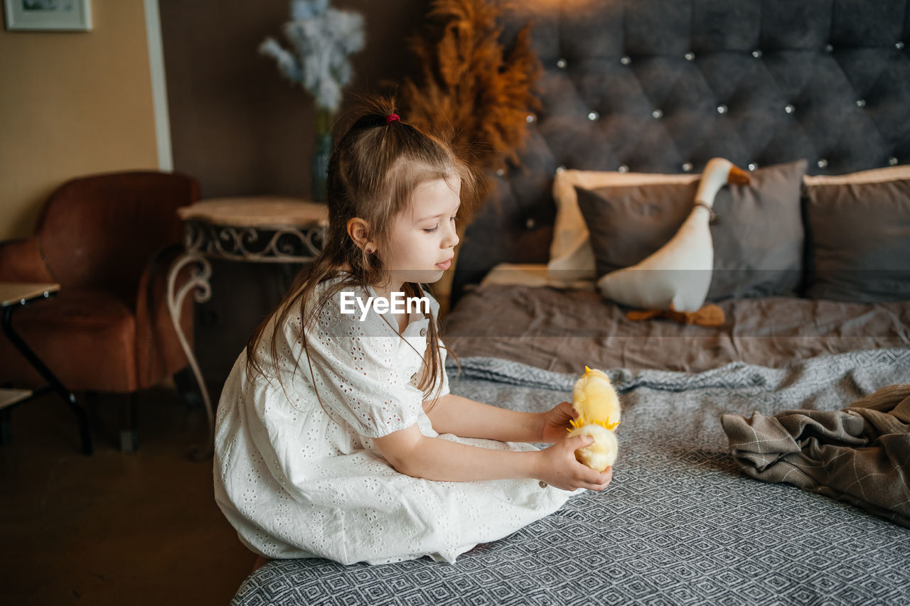 Little girl playing on the bed. high quality photo
