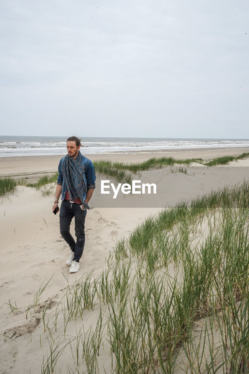 A men walking alone on the beach