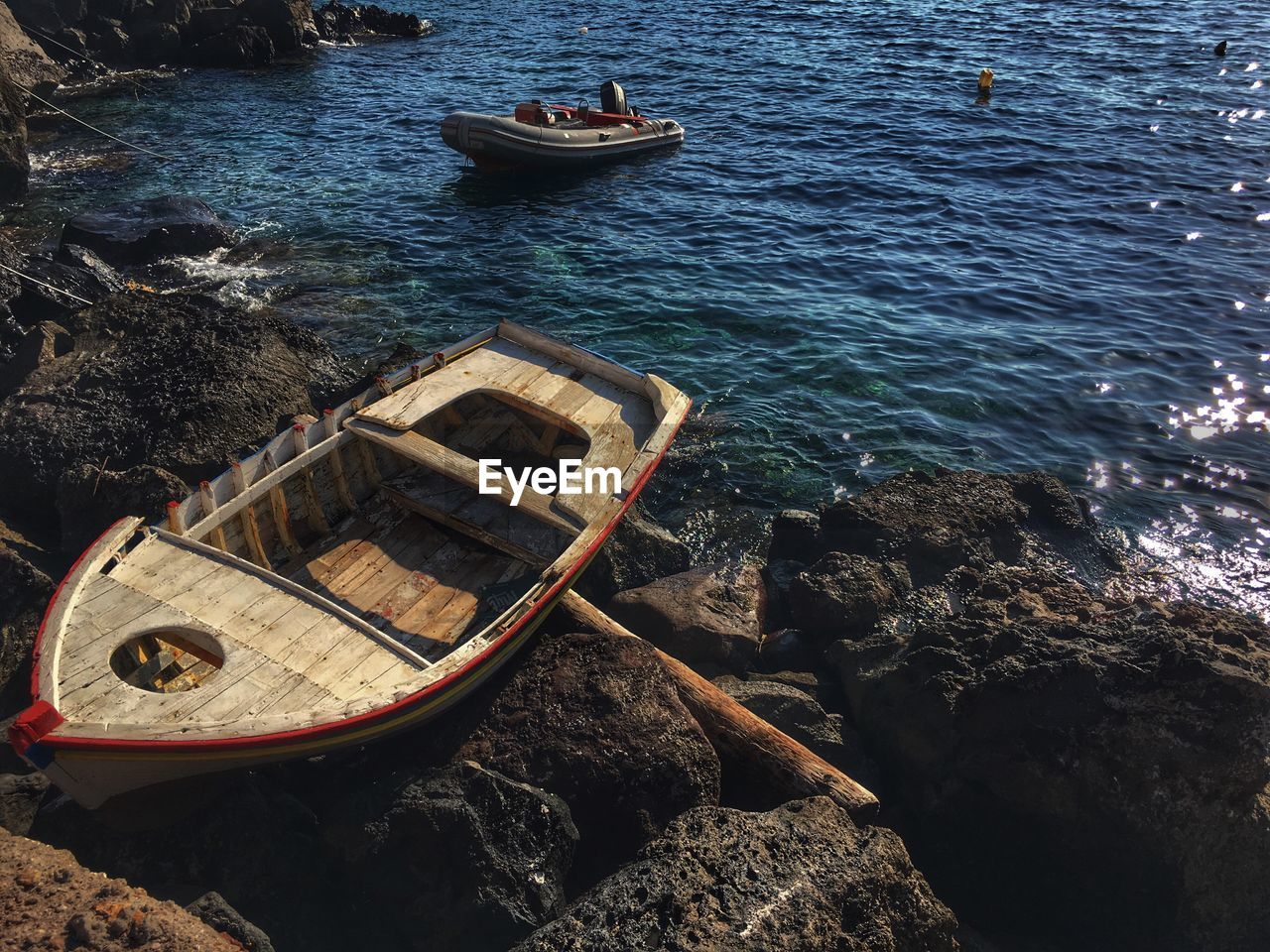 High angle view of boat on rock against sea