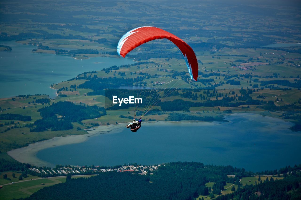 Person paragliding in sky