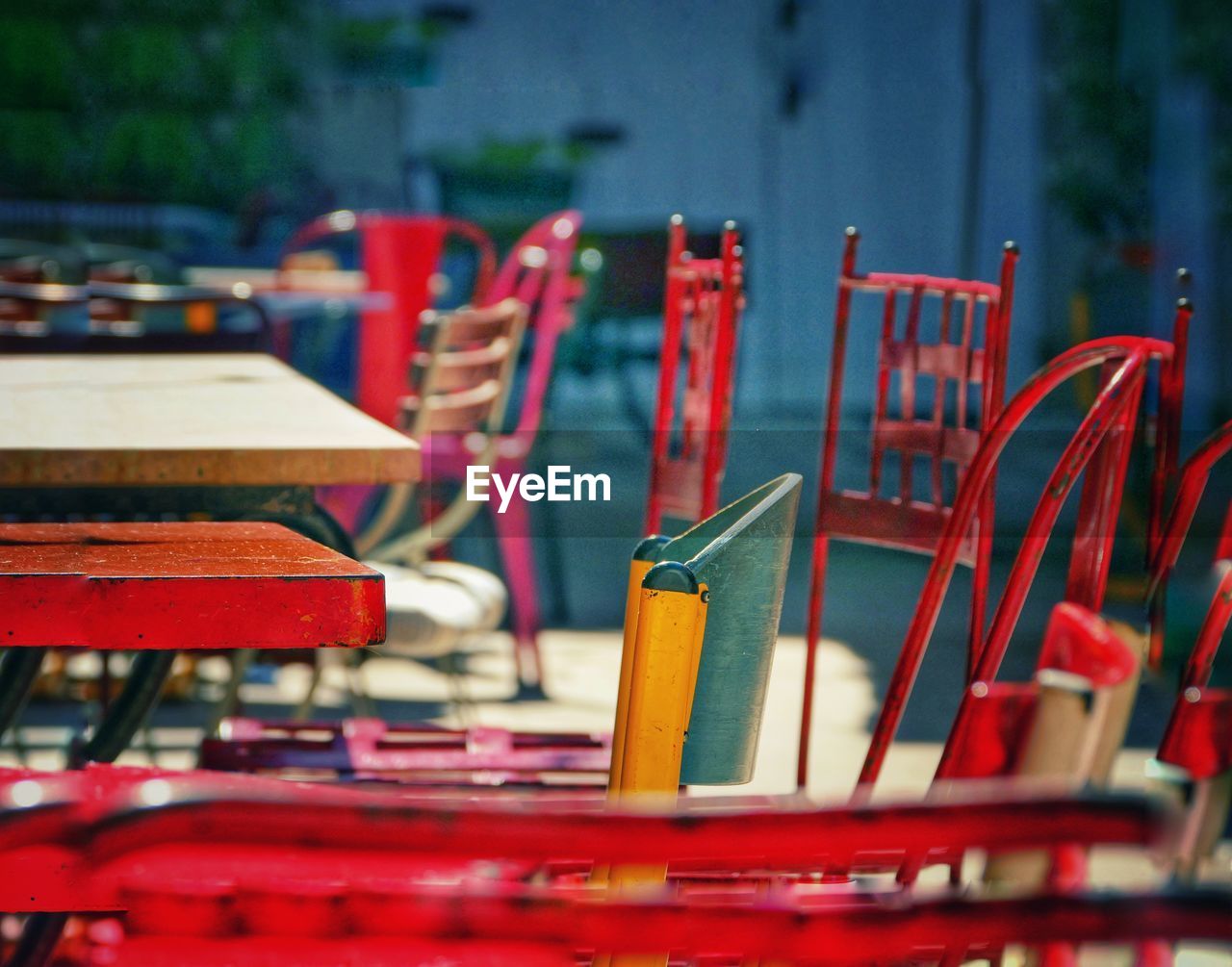 Close-up of empty chairs and table in cafe