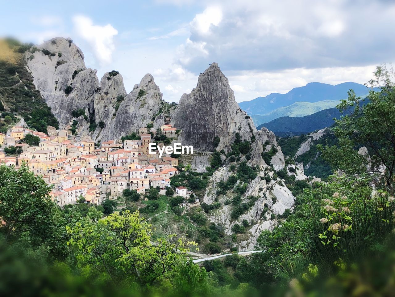 Panoramic view of townscape and mountains against sky