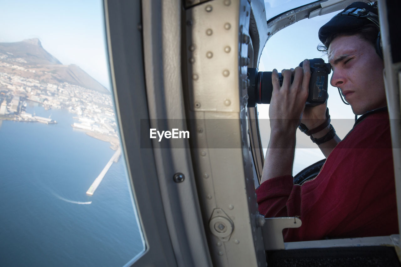 Men photographing from helicopter