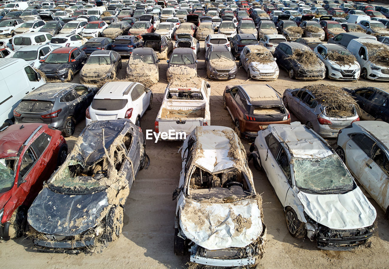 high angle view, in a row, mode of transportation, transportation, day, car, no people, outdoors, sunlight, motor vehicle, large group of objects, abundance, land vehicle, nature, side by side, moored, water, land, stack, order