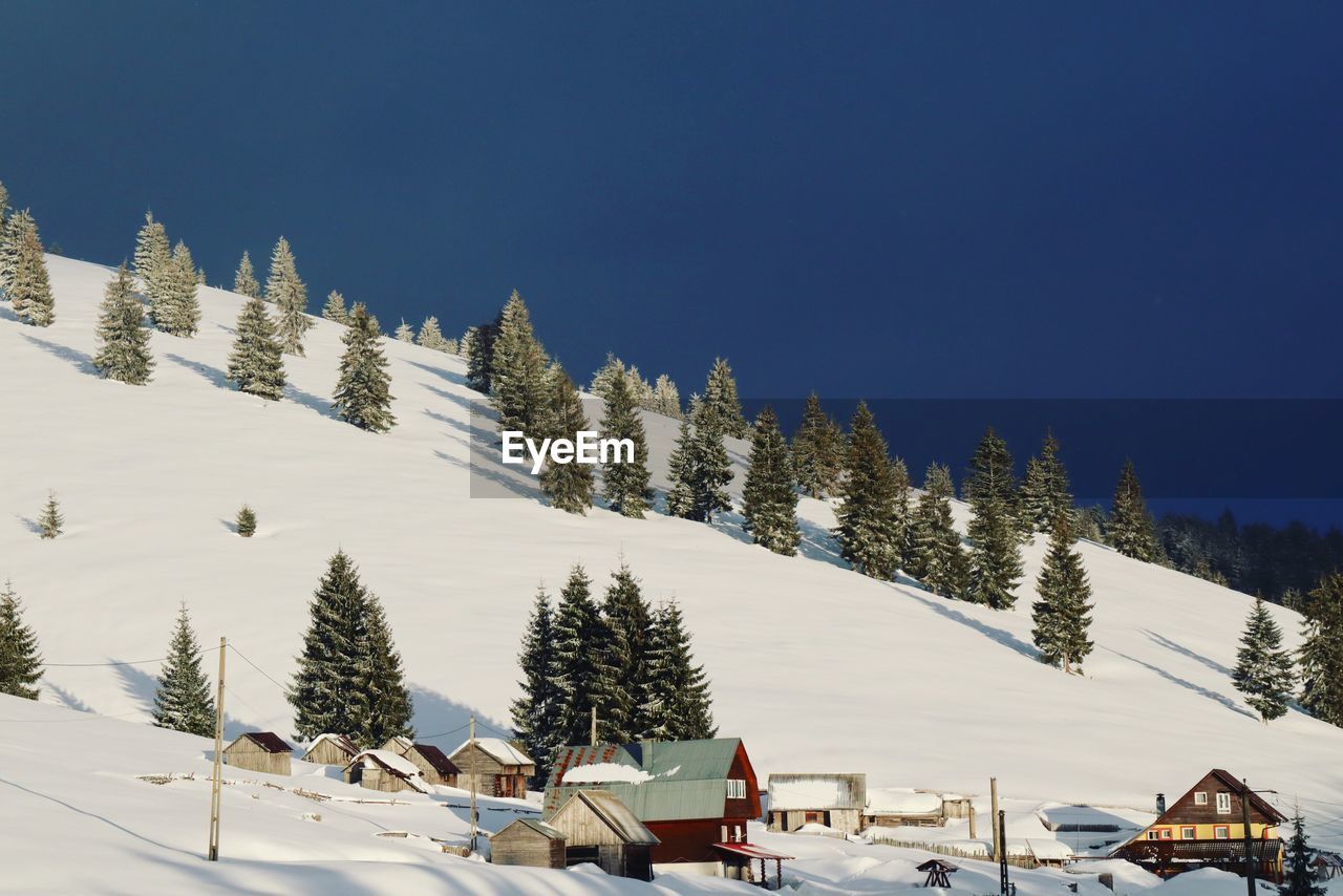 Scenic view of snow covered mountains against sky