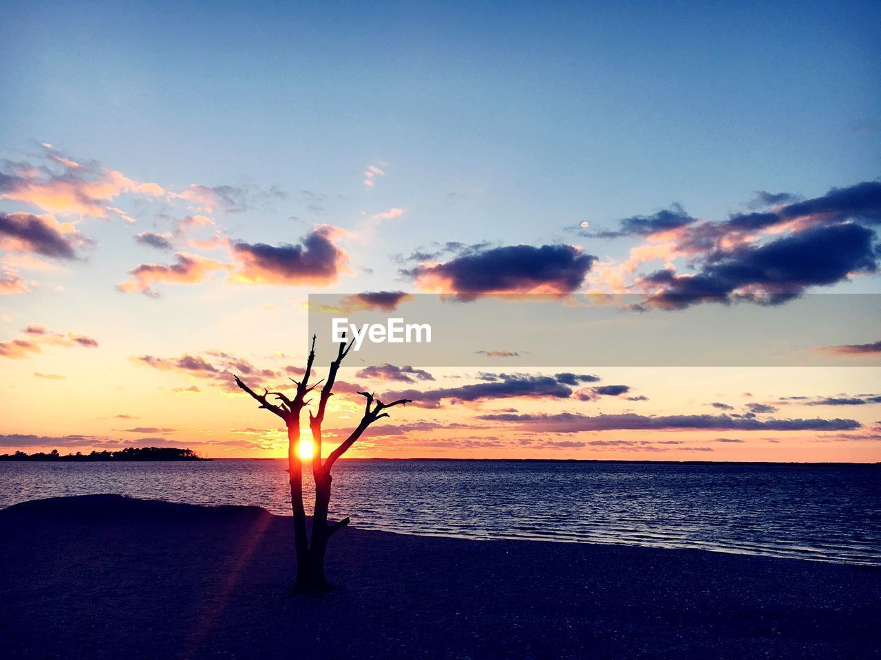 Scenic view of sea against sky at sunset