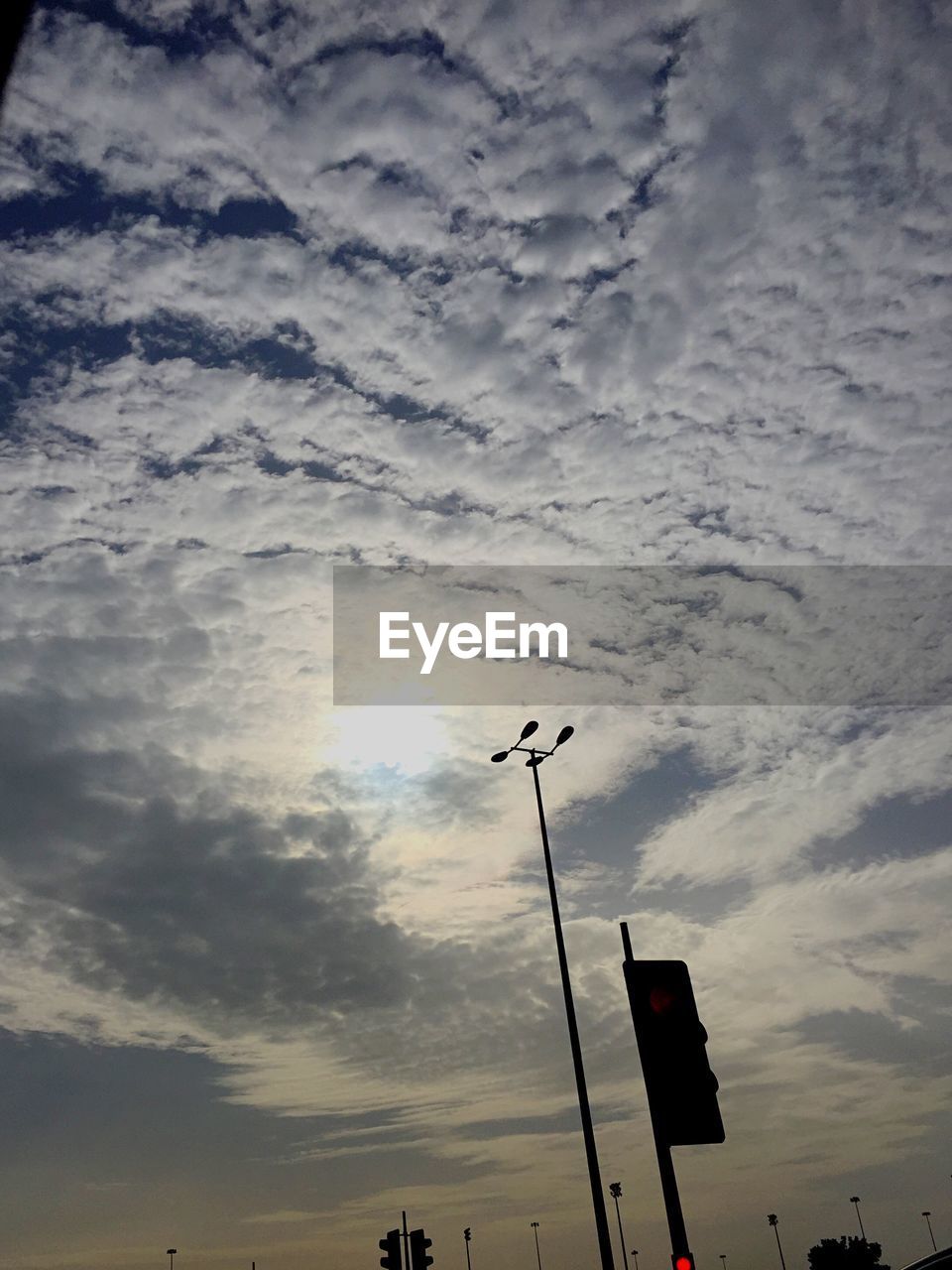 LOW ANGLE VIEW OF STREET LIGHT AGAINST CLOUDY SKY