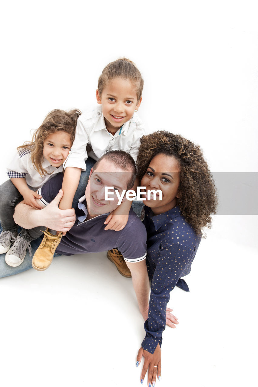 Beautiful multiethnic caucasian and brazilian family on the white background. happy mother's day