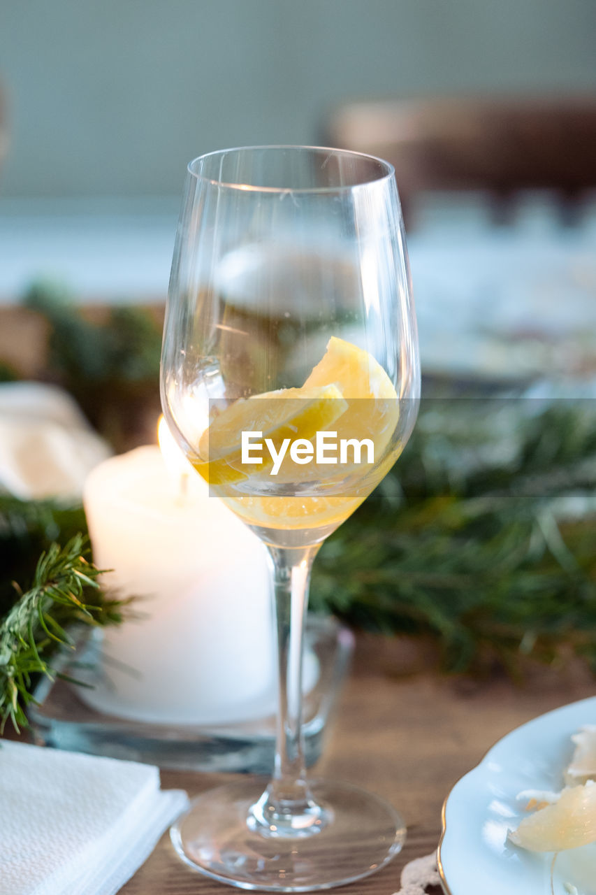 A glass of alcohol on the new year's table. glass of cocktail with lemon in a glass