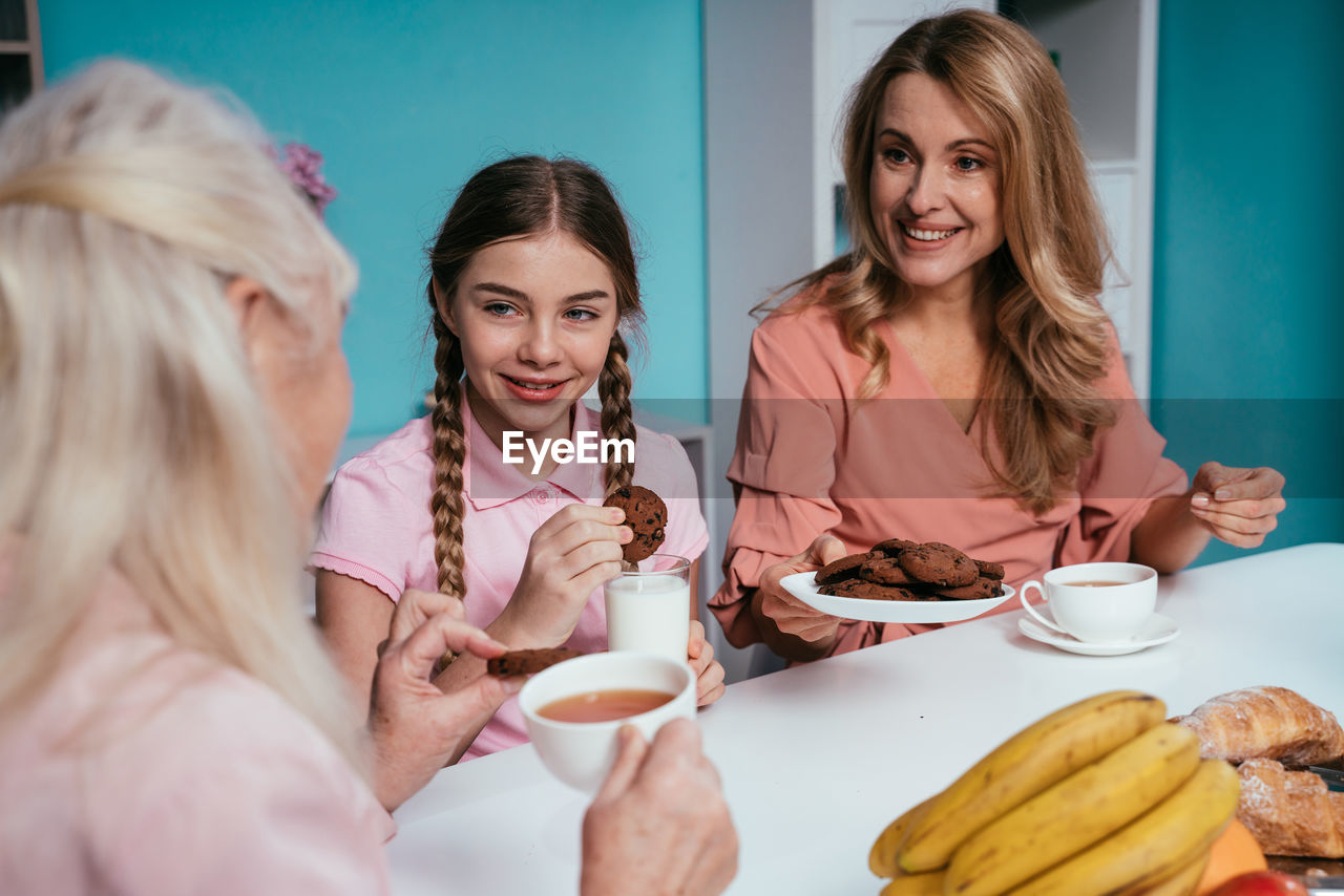 Cheerful family enjoying breakfast at home