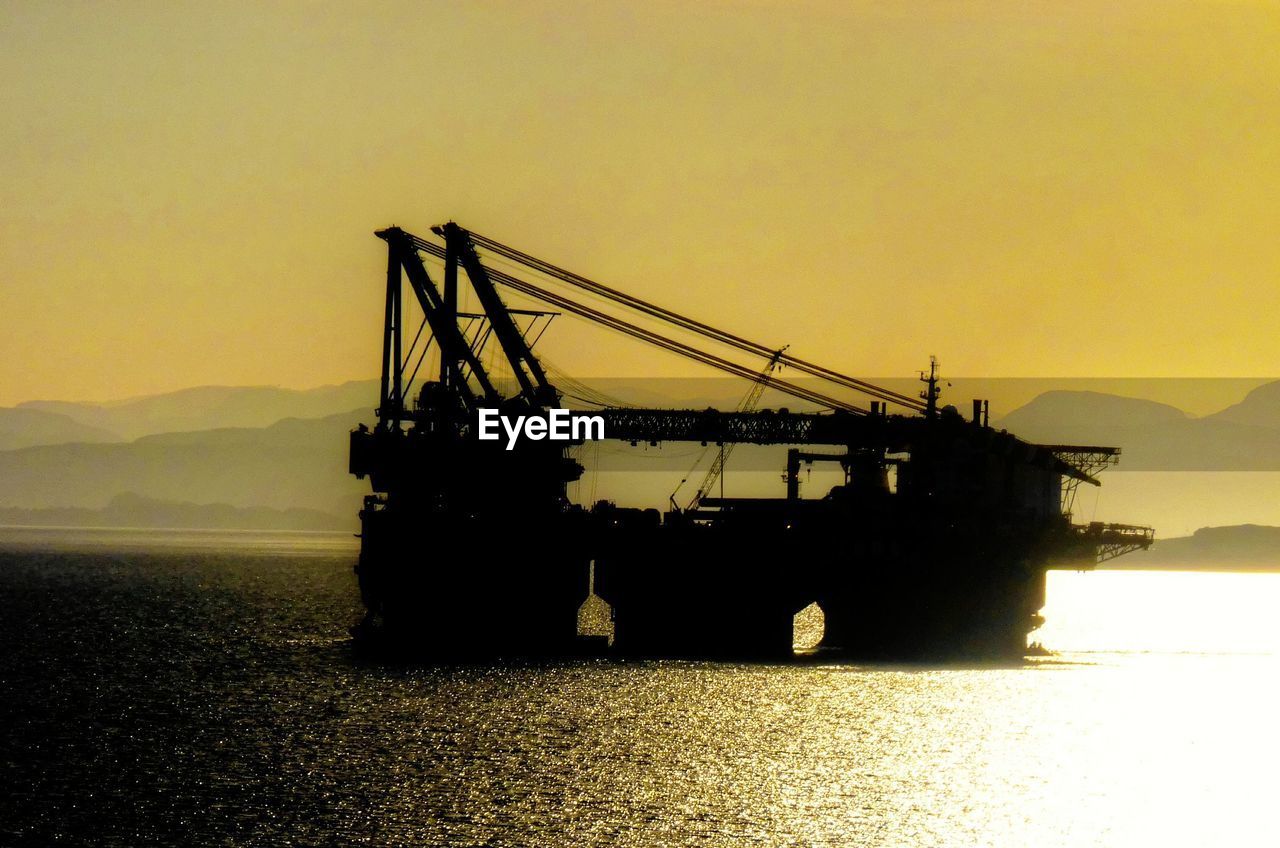 SILHOUETTE OF CRANES AT SUNSET