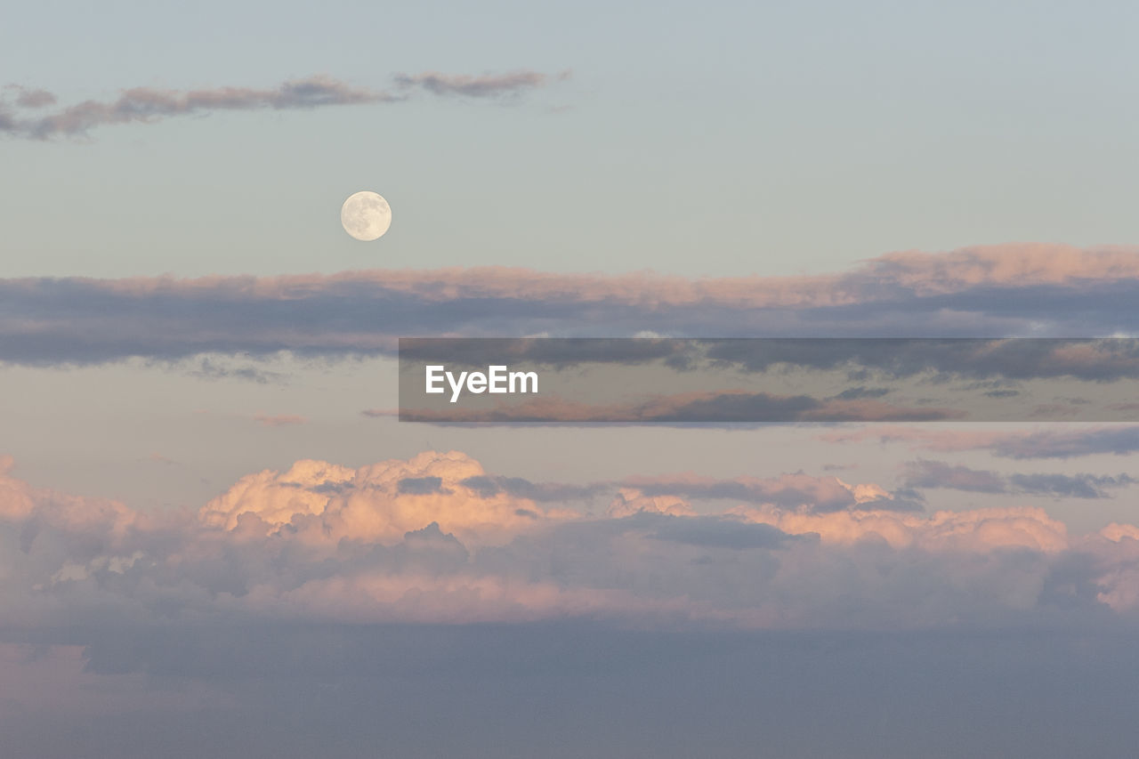 Low angle view of moon against sky at sunset