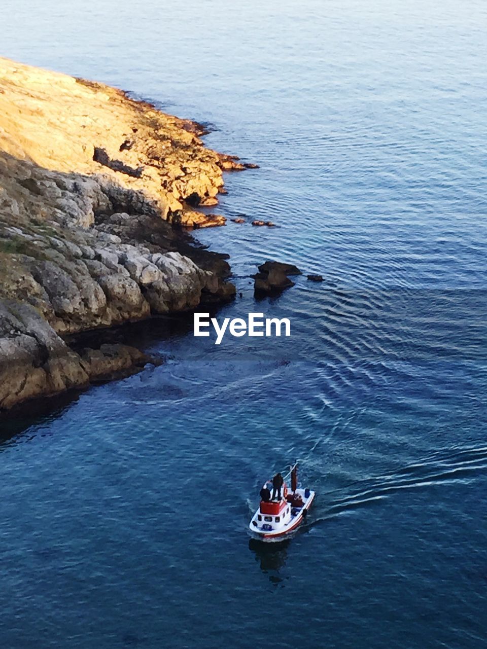 High angle view of man standing in boat on sea
