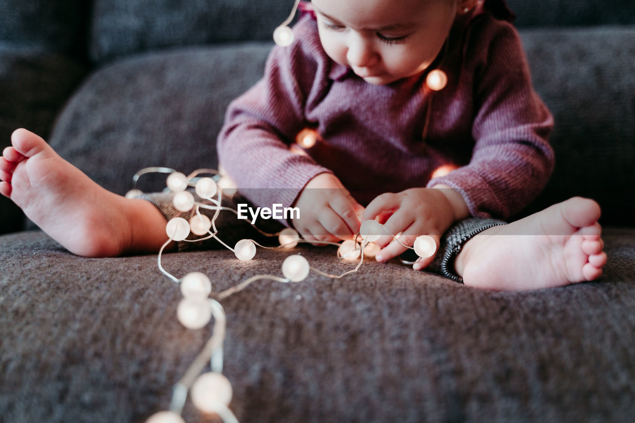 Portrait of cute baby girl sitting