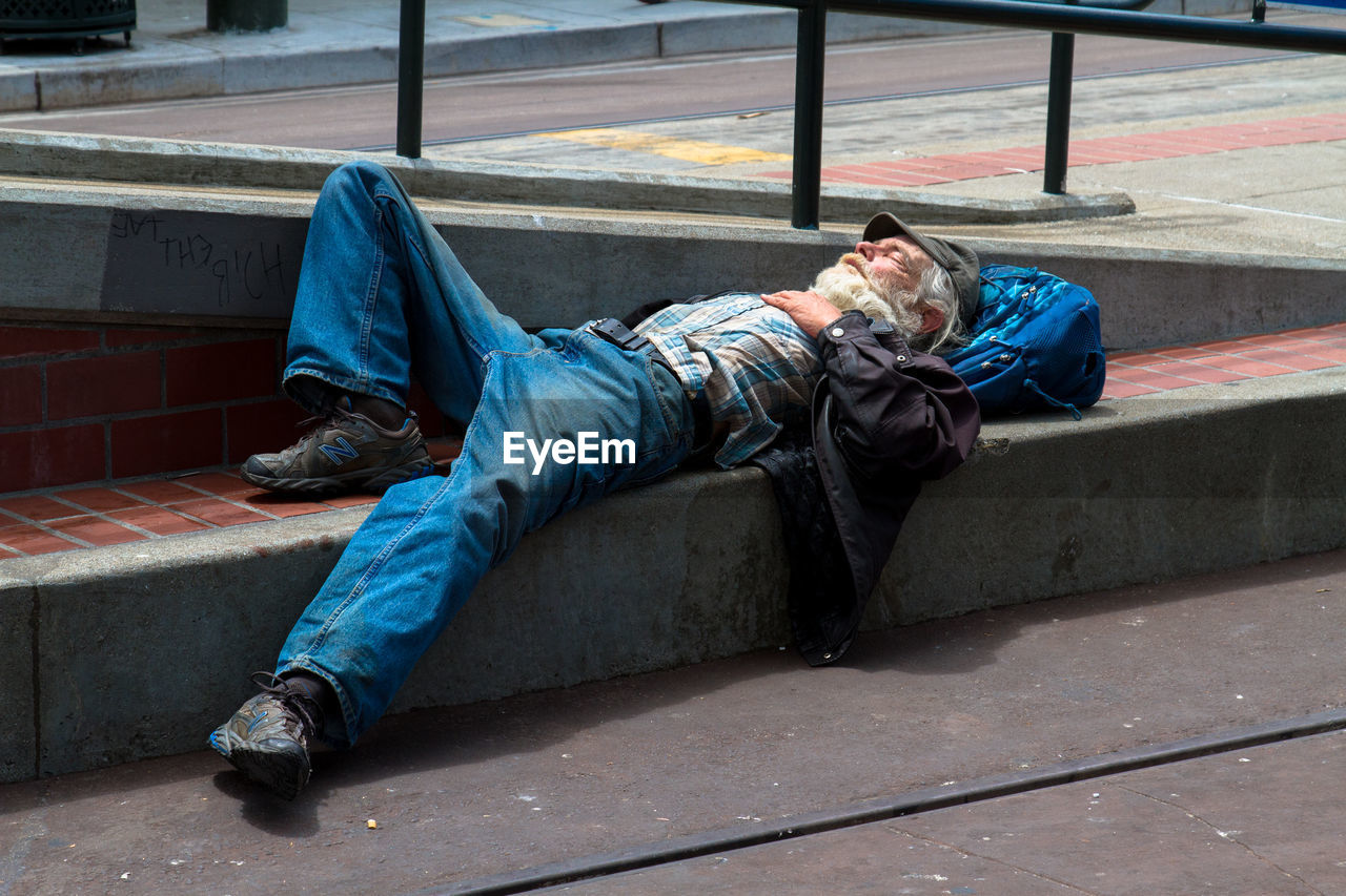 MAN SLEEPING IN STREET