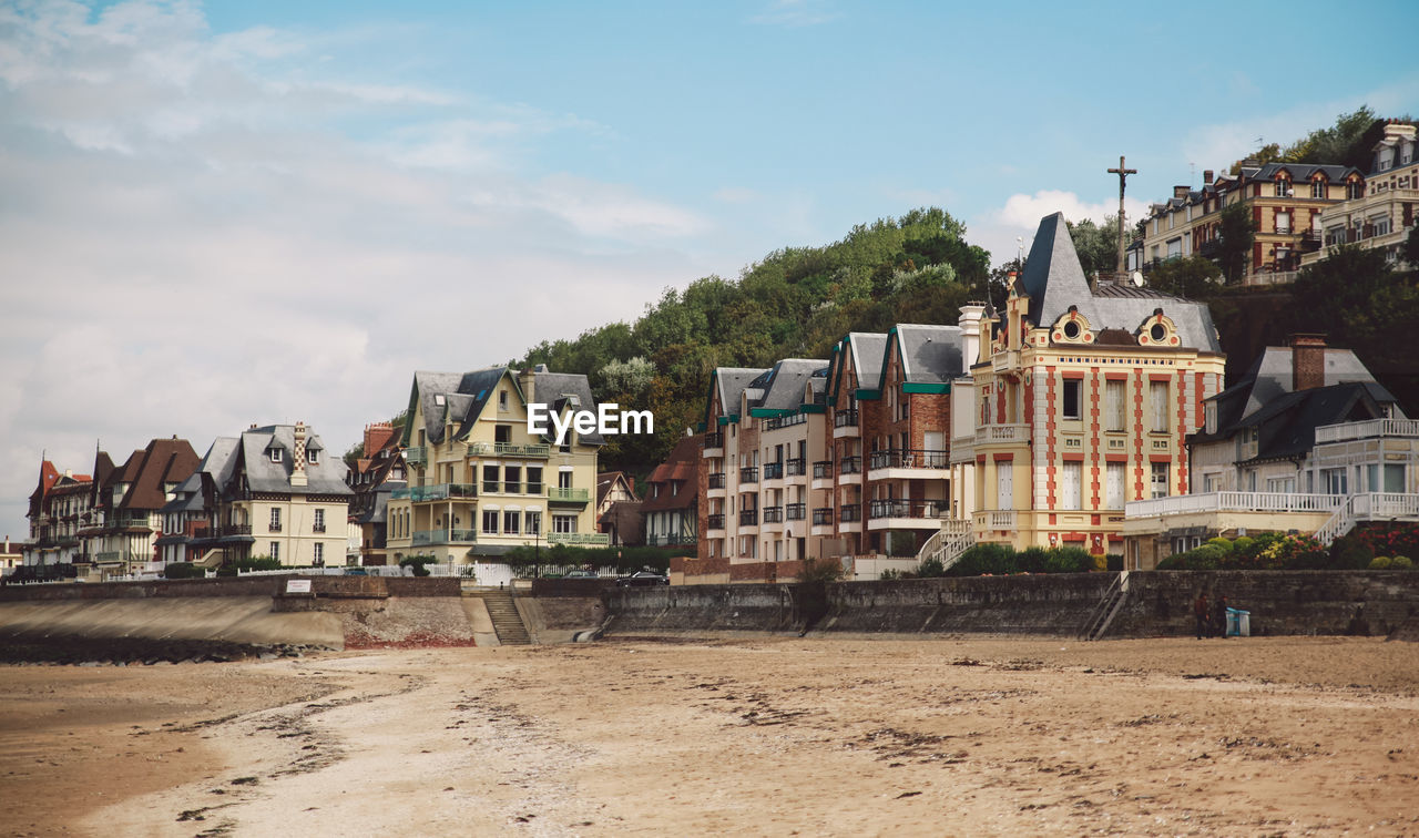 Houses in city against sky