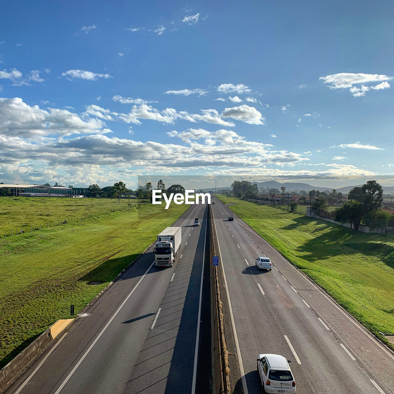 CARS ON HIGHWAY AGAINST SKY