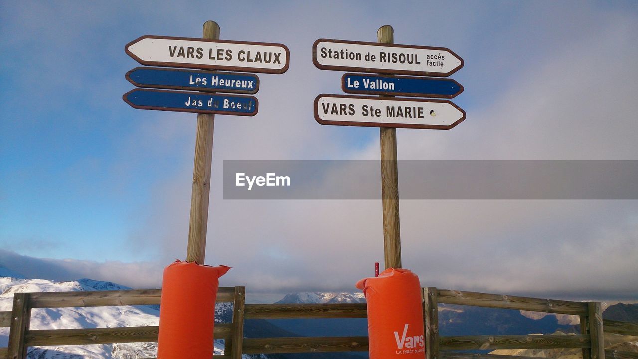 LOW ANGLE VIEW OF SIGNBOARD AGAINST SKY