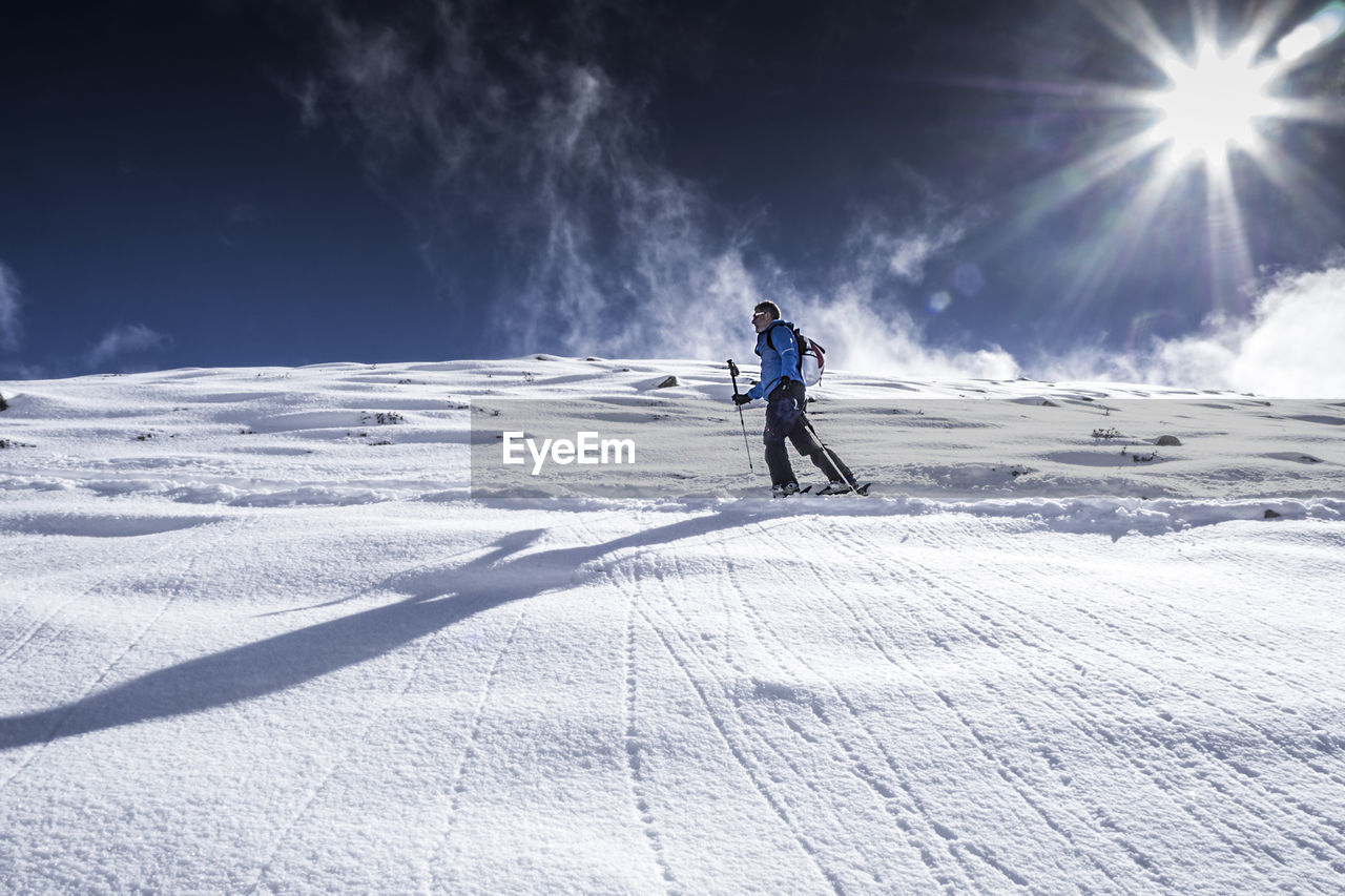 Full length of person skiing on snowcapped mountain against sky