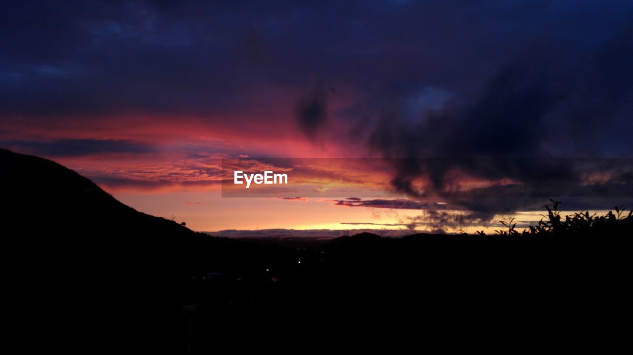 SCENIC VIEW OF SILHOUETTE MOUNTAINS AGAINST SKY