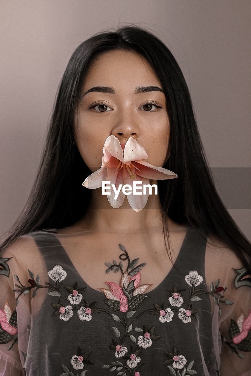 PORTRAIT OF A BEAUTIFUL YOUNG WOMAN IN FLOWER