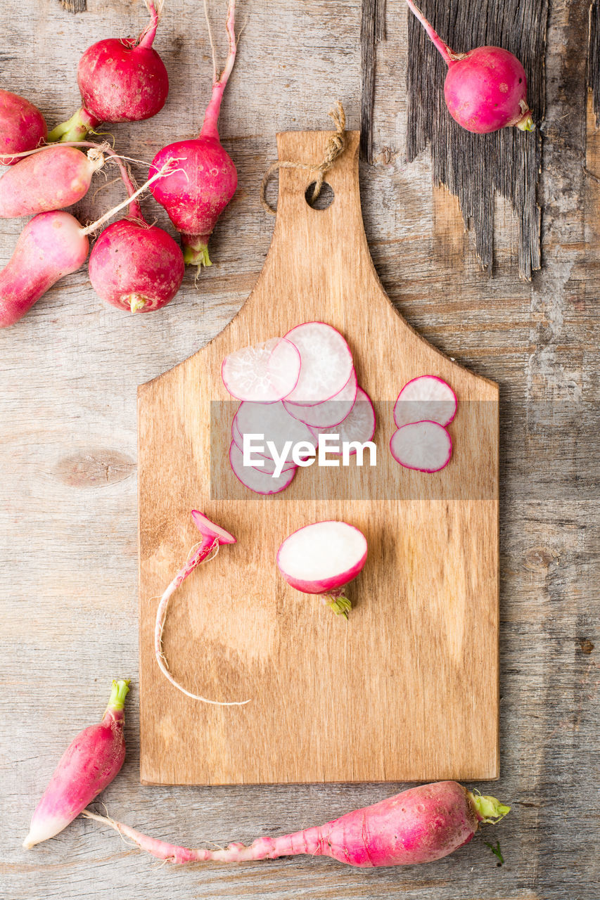 Fresh sliced radish on a cutting board on a wooden table. vegetables for a vegetarian diet