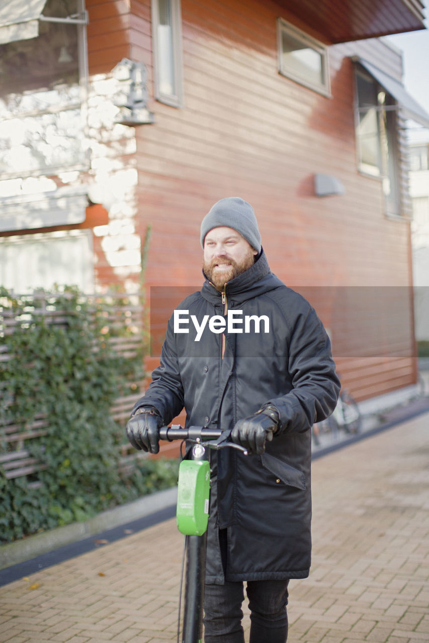 Man holding electric scooter