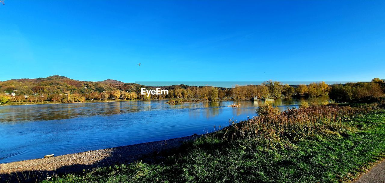 LAKE AGAINST CLEAR BLUE SKY