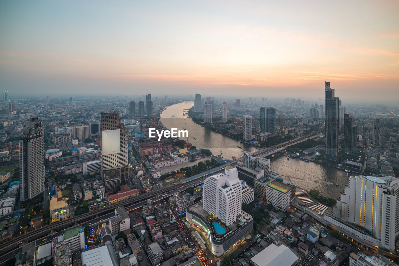 High angle view of city buildings during sunset